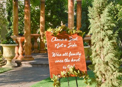 Garden Tuscana Reception Hall event in Mesa showing sign in garden wedding ceremony