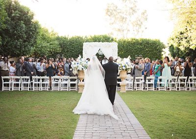 Garden Tuscana Reception Hall event in Mesa showing couple walking down aisle