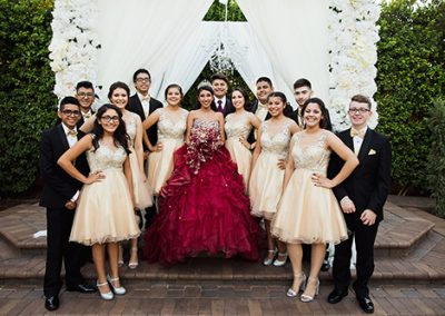 Garden Tuscana Reception Hall event in Mesa showing Quinceanera posing outside with guests
