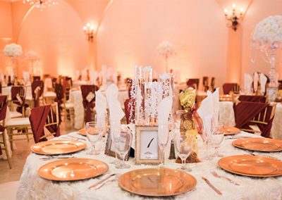 Garden Tuscana Reception Hall event in Mesa showing red and gold custom table decor in wedding reception