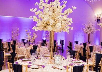 Garden Tuscana Reception Hall event in Mesa showing purple and gold custom table decor in wedding reception