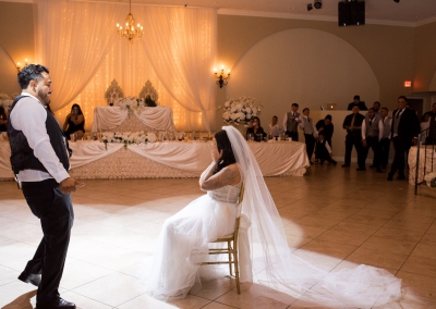 Garden Tuscana Reception Hall event in Mesa showing bride and groom removing garder