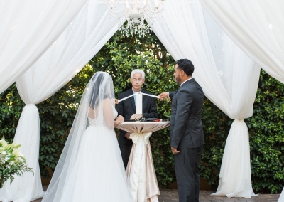 Garden Tuscana Reception Hall event in Mesa showing couple lighting candles at wedding ceremony