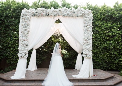 Garden Tuscana Reception Hall event in Mesa showing bride posing at draped altar