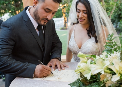 Garden Tuscana Reception Hall event in Mesa showing newlywed couple signing marriage license