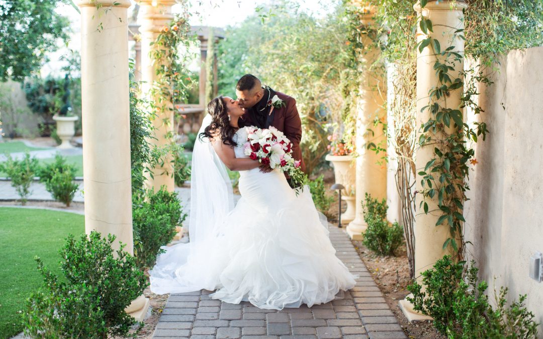 Garden Tuscana Reception Hall event in Mesa showing couple kissing outdoor wedding
