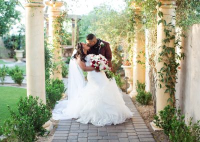 Garden Tuscana Reception Hall event in Mesa showing couple kissing outdoor wedding