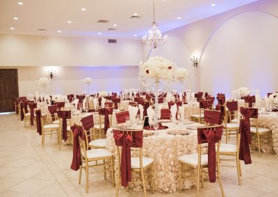 Garden Tuscana Reception Hall event in Mesa showing red and white custom table decor in ballroom