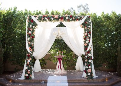 Garden Tuscana Reception Hall event in Mesa showing Rose decorated outdoor wedding altar