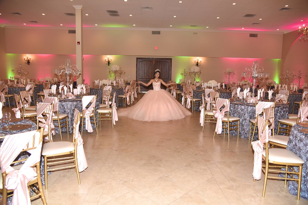 Quinceañera reception table with centerpiece, linens and place settings at Garden Tuscana